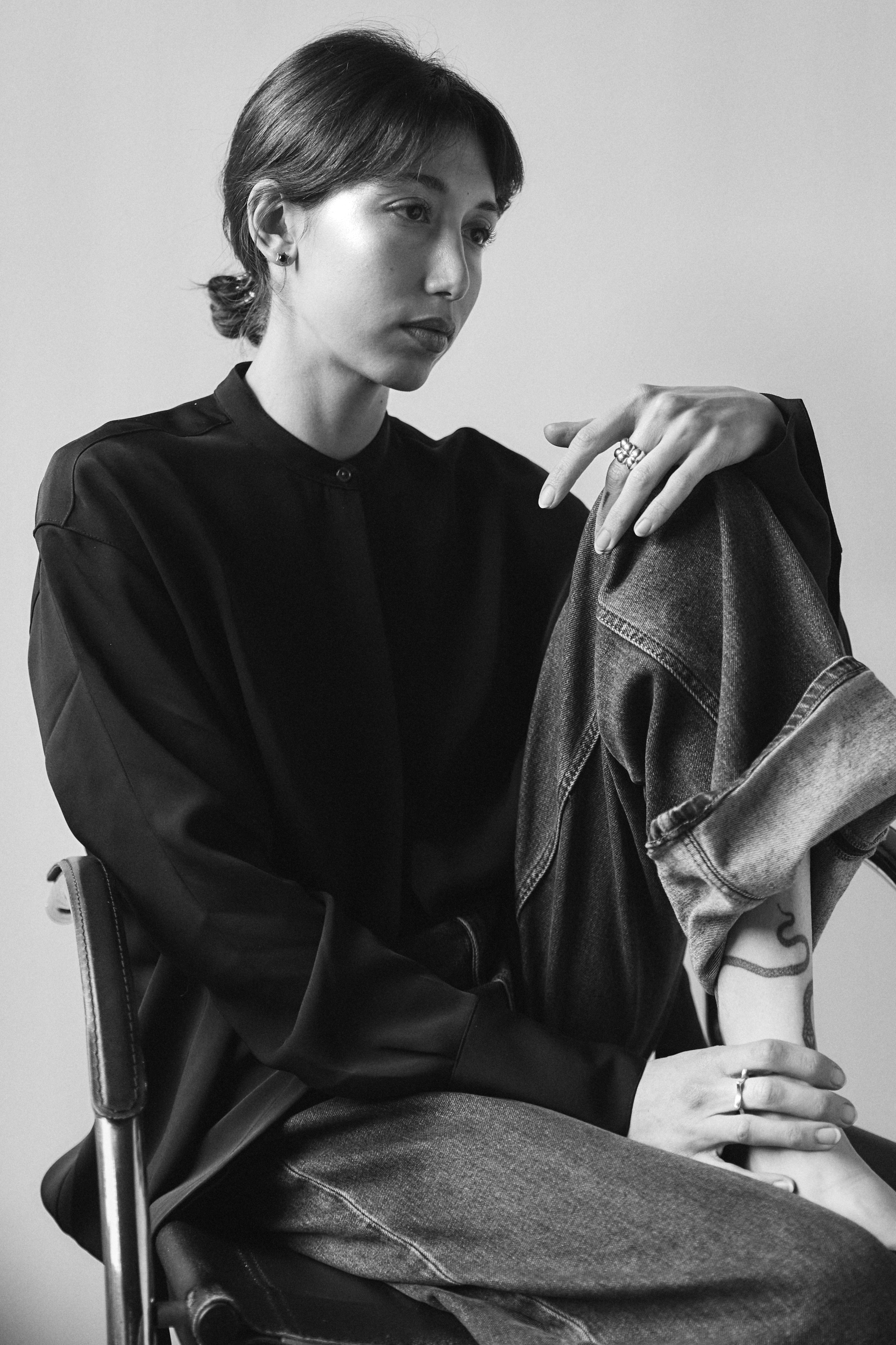 Black and white portrait of Luciana Florio seated with jewelry.